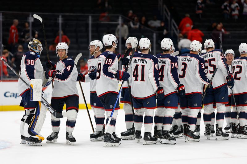 Sep 27, 2024; Washington, District of Columbia, USA; Columbus Blue Jackets players celebrate after their game against the Washington Capitals at Capital One Arena. Mandatory Credit: Geoff Burke-Imagn Images