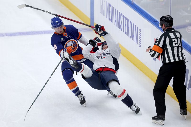 Oct 11, 2025; Elmont, New York, USA; New York Islanders defenseman Matthew Schaefer (48) upends Washington Capitals right wing Ryan Leonard (9) during the third period at UBS Arena. Mandatory Credit: Brad Penner-Imagn Images