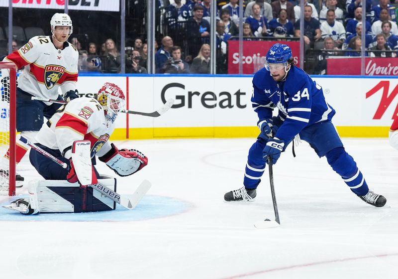 May 7, 2025; Toronto, Ontario, CAN; Toronto Maple Leafs center Auston Matthews (34) battles for the puck in front of Florida Panthers goaltender Sergei Bobrovsky (72) during the third period in game two of the second round of the 2025 Stanley Cup Playoffs at Scotiabank Arena. Mandatory Credit: Nick Turchiaro-Imagn Images