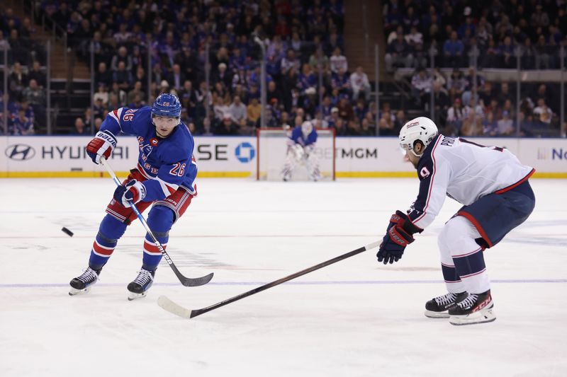 Feb 28, 2024; New York, New York, USA; New York Rangers left wing Jimmy Vesey (26) plays the puck past Columbus Blue Jackets defenseman Ivan Provorov (9) during the second period at Madison Square Garden. Mandatory Credit: Brad Penner-USA TODAY Sports