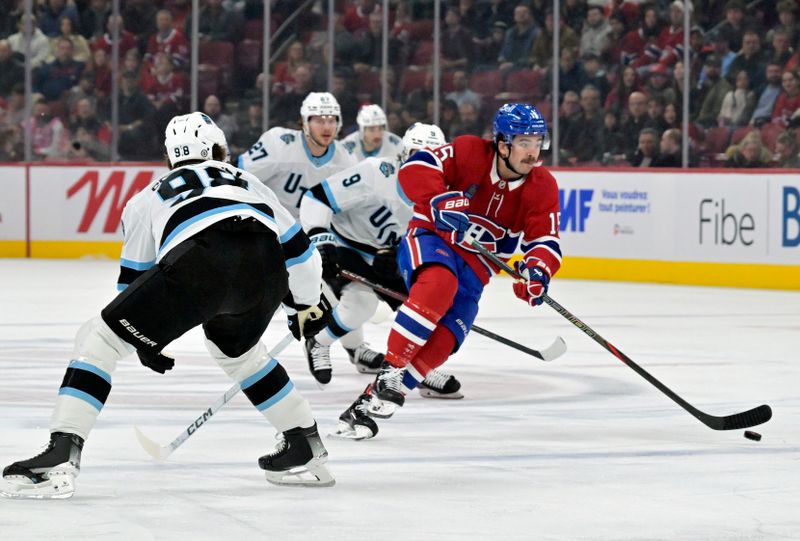 Nov 26, 2024; Montreal, Quebec, CAN; Montreal Canadiens forward Alex Newhook (15) plays the puck against Utah Hockey Club defenseman Mikhail Sergachev (98) during the first period at the Bell Centre. Mandatory Credit: Eric Bolte-Imagn Images