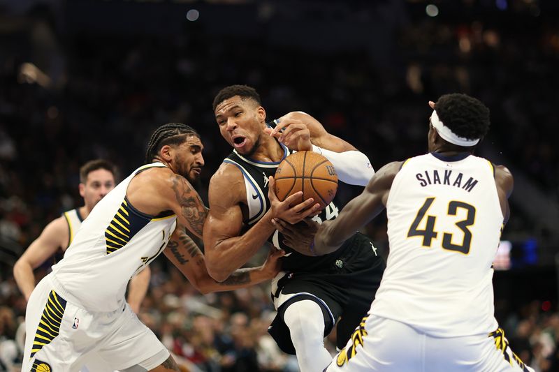 MILWAUKEE, WISCONSIN - NOVEMBER 22: Giannis Antetokounmpo #34 of the Milwaukee Bucks is defended by Obi Toppin #1 and Pascal Siakam #43 of the Indiana Pacers during the second half of a game in the NBA Emirates Cup at Fiserv Forum on November 22, 2024 in Milwaukee, Wisconsin. NOTE TO USER: User expressly acknowledges and agrees that, by downloading and or using this photograph, User is consenting to the terms and conditions of the Getty Images License Agreement. (Photo by Stacy Revere/Getty Images)