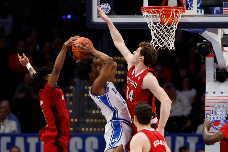 Mar 14, 2024; Washington, D.C., USA; North Carolina State guard Jayden Taylor (1) blocks the shot of Duke Blue Devils forward Sean Stewart (13) in the first half at Capital One Arena. Mandatory Credit: Geoff Burke-USA TODAY Sports