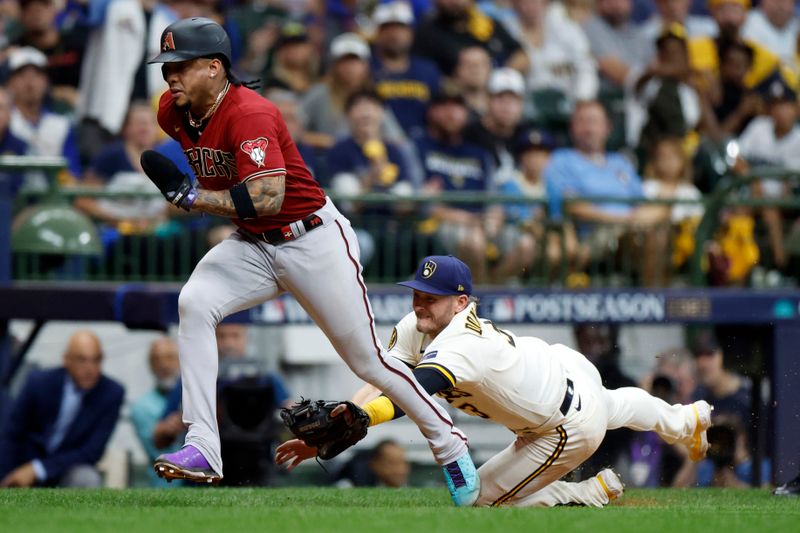 Oct 4, 2023; Milwaukee, Wisconsin, USA; Milwaukee Brewers third baseman Josh Donaldson (3) attempts to tag Arizona Diamondbacks second baseman Ketel Marte (4) in the sixth inning during game two of the Wildcard series for the 2023 MLB playoffs at American Family Field. Mandatory Credit: Kamil Krzaczynski-USA TODAY Sports