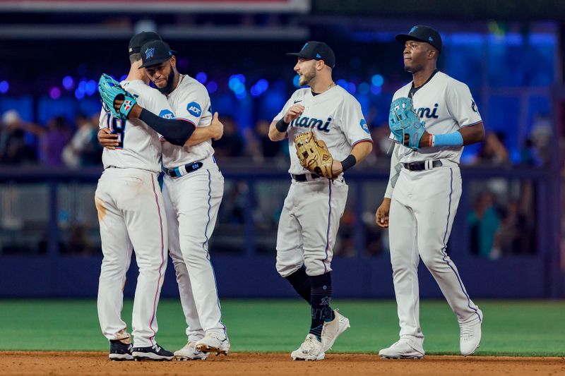 Jun 4, 2023; Miami, Florida, USA; Miami Marlins left fielder Bryan De La Cruz (14) celebrates with shortstop Joey Wendle (18) after winning the game against the Oakland Athletics at loanDepot Park. Mandatory Credit: Sam Navarro-USA TODAY Sports