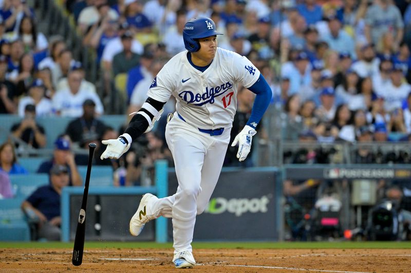 Oct 13, 2024; Los Angeles, California, USA; Los Angeles Dodgers two-way player Shohei Ohtani (17) hits a RBI single against the New York Mets in the second inning during game one of the NLCS for the 2024 MLB Playoffs at Dodger Stadium. Mandatory Credit: Jayne Kamin-Oncea-Imagn Images