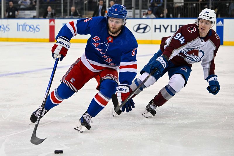 Feb 5, 2024; New York, New York, USA;  New York Rangers defenseman Zac Jones (6) skates with the puck defended by Colorado Avalanche left wing Joel Kiviranta (94) during the first period at Madison Square Garden. Mandatory Credit: Dennis Schneidler-USA TODAY Sports