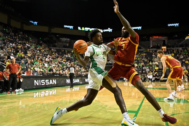 Dec 2, 2025; Eugene, Oregon, USA; Oregon Ducks forward Dezdrick Lindsay (4) drives to the basket against Southern California Trojans forward Amarion Dickerson (3) during the first half at Matthew Knight Arena. Mandatory Credit: Craig Strobeck-Imagn Images
