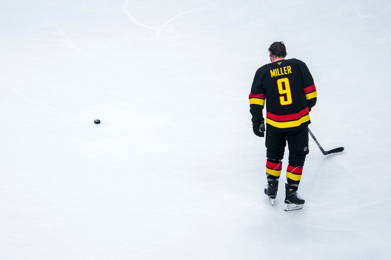 Jan 21, 2025; Vancouver, British Columbia, CAN; Vancouver Canucks forward J.T. Miller (9) looks at a puck during warm up prior to a game against the Buffalo Sabres at Rogers Arena. Mandatory Credit: Bob Frid-Imagn Images