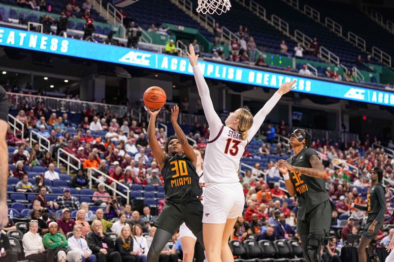 Mar 8, 2024; Greensboro, NC, USA; Miami Hurricanes guard Shayeann Day-Wilson (30) shoots the ball over Virginia Tech Hokies center Clara Strack (13) in the second half at Greensboro Coliseum. Mandatory Credit: David Yeazell-USA TODAY Sports