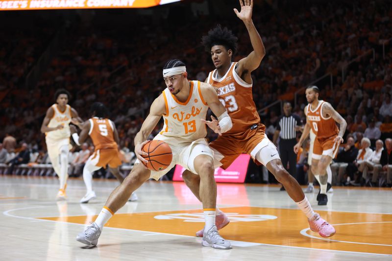 Jan 28, 2023; Knoxville, Tennessee, USA; Tennessee Volunteers forward Olivier Nkamhoua (13) moves the ball against the Texas Longhorns during the second half at Thompson-Boling Arena. Mandatory Credit: Randy Sartin-USA TODAY Sports