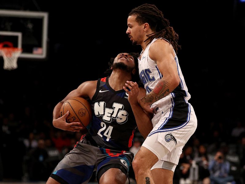 NEW YORK, NEW YORK - DECEMBER 02: Cam Thomas #24 of the Brooklyn Nets collides with Cole Anthony #50 of the Orlando Magic during the first half at Barclays Center on December 02, 2023 in New York City. NOTE TO USER: User expressly acknowledges and agrees that, by downloading and or using this photograph, User is consenting to the terms and conditions of the Getty Images License Agreement. (Photo by Elsa/Getty Images)