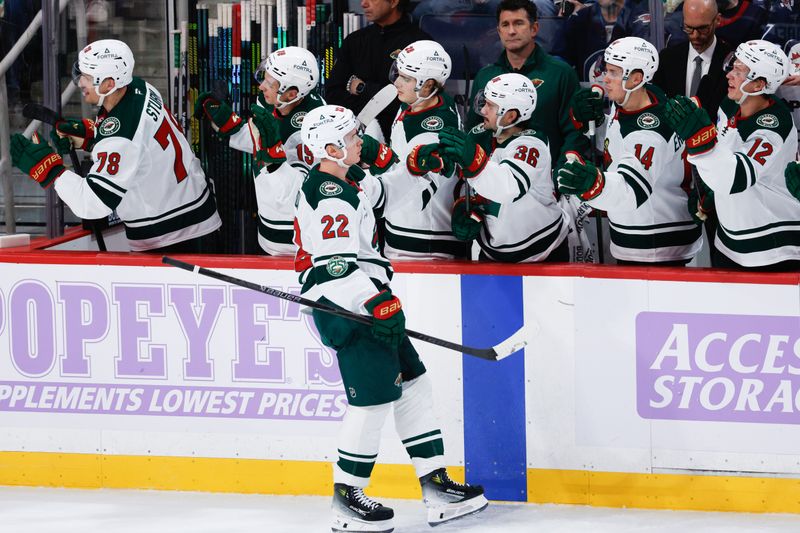 Nov 23, 2025; Winnipeg, Manitoba, CAN;  Minnesota Wild forward Danila Yurov (22) is congratulated by his team mates on his goal against the Winnipeg Jets during the second period at Canada Life Centre. Mandatory Credit: Terrence Lee-Imagn Images