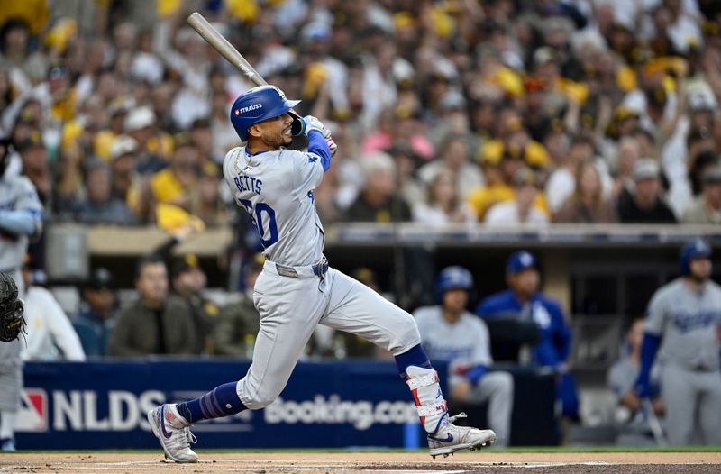 Oct 9, 2024; San Diego, California, USA; Los Angeles Dodgers shortstop Mookie Betts (50) hits a home run in the first inning against the San Diego Padres during game four of the NLDS for the 2024 MLB Playoffs at Petco Park.  Mandatory Credit: Denis Poroy-Imagn Images