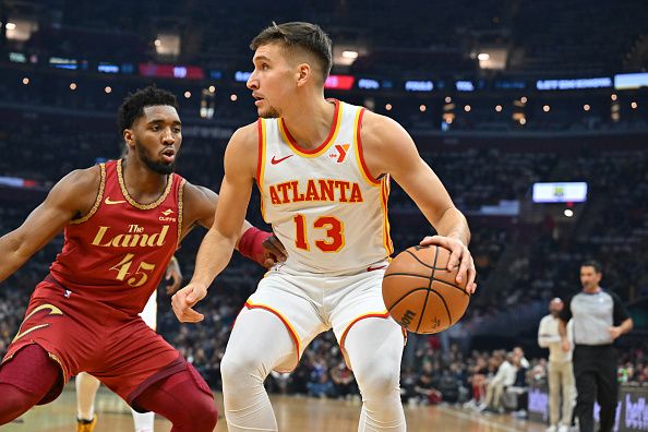 CLEVELAND, OHIO - NOVEMBER 28: Donovan Mitchell #45 of the Cleveland Cavaliers guards Bogdan Bogdanovic #13 of the Atlanta Hawks during the first half of an NBA In-Season Tournament game at Rocket Mortgage Fieldhouse on November 28, 2023 in Cleveland, Ohio. NOTE TO USER: User expressly acknowledges and agrees that, by downloading and or using this photograph, User is consenting to the terms and conditions of the Getty Images License Agreement. (Photo by Jason Miller/Getty Images)