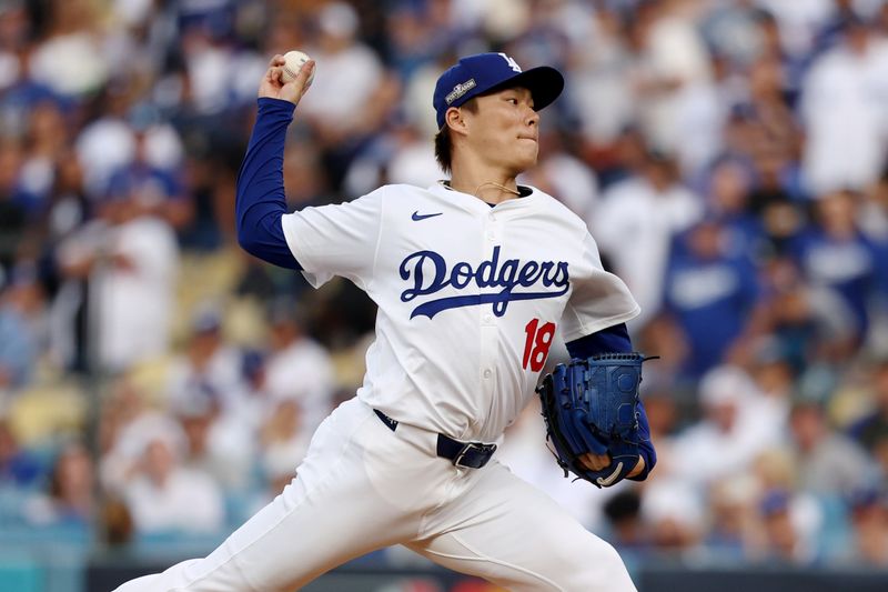 Oct 11, 2024; Los Angeles, California, USA; Los Angeles Dodgers pitcher Yoshinobu Yamamoto (18) pitches against the San Diego Padres in the first inning during game five of the NLDS for the 2024 MLB Playoffs at Dodger Stadium. Mandatory Credit: Kiyoshi Mio-Imagn Images