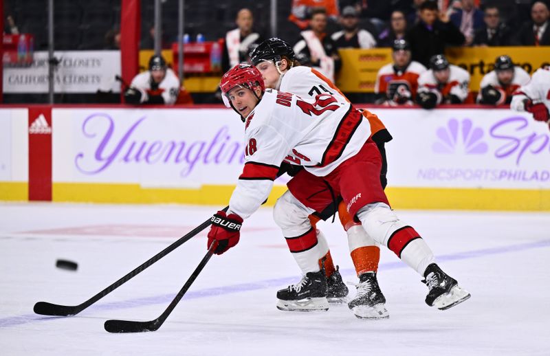 sNov 28, 2023; Philadelphia, Pennsylvania, USA; Carolina Hurricanes center Jack Drury (18) passes the puck against Philadelphia Flyers right wing Owen Tippett (74) in the third period at Wells Fargo Center. Mandatory Credit: Kyle Ross-USA TODAY Sports