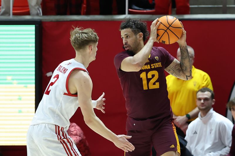 Feb 10, 2024; Salt Lake City, Utah, USA; Arizona State Sun Devils guard Jose Perez (12) holds the ball away from Utah Utes guard Cole Bajema (2) during the second half at Jon M. Huntsman Center. Mandatory Credit: Rob Gray-USA TODAY Sports