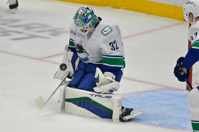 Nov 5, 2024; Anaheim, California, USA; Vancouver Canucks goaltender Kevin Lankinen (32) makes a save in the first period against the Anaheim Ducks at Honda Center. Mandatory Credit: Jayne Kamin-Oncea-Imagn Images