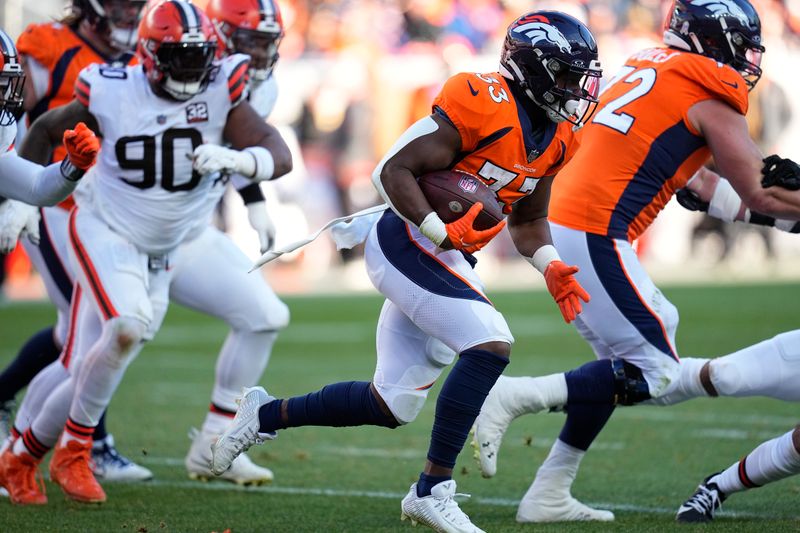 Denver Broncos running back Javonte Williams (33) runs with the ball during the first half of an NFL football game against the Cleveland Browns on Sunday, Nov. 26, 2023, in Denver. (AP Photo/Jack Dempsey)