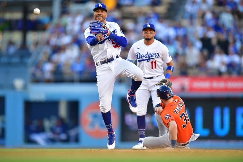 Jun 24, 2023; Los Angeles, California, USA; Houston Astros right fielder Kyle Tucker (30) is out at second as Los Angeles Dodgers second baseman Mookie Betts (50) throws to first for the out against first baseman Jose Abreu (79) during the ninth inning at Dodger Stadium. Mandatory Credit: Gary A. Vasquez-USA TODAY Sports