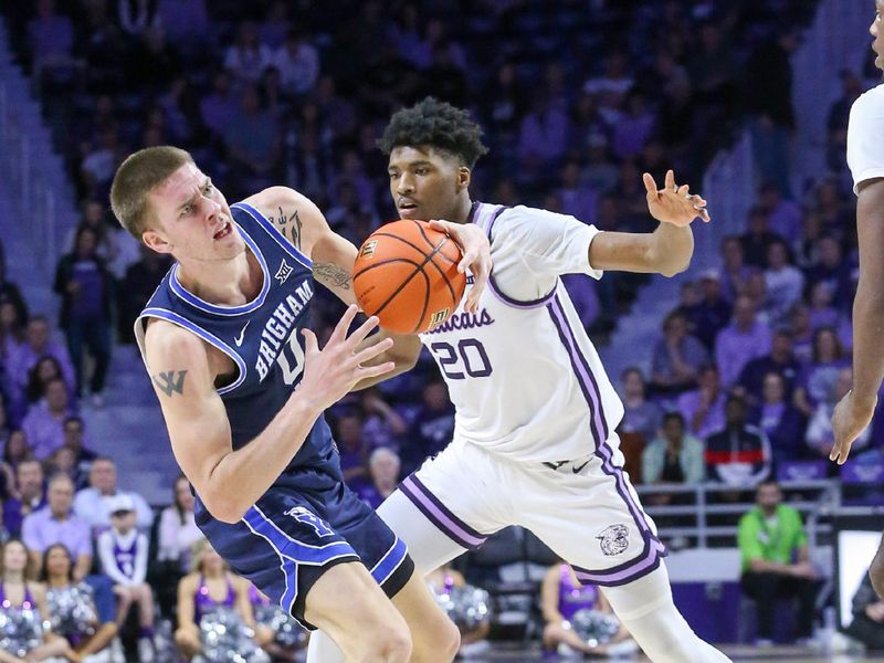 Feb 24, 2024; Manhattan, Kansas, USA; Brigham Young Cougars forward Noah Waterman (0) is guarded by Kansas State Wildcats forward Jerrell Colbert (20) during the second half at Bramlage Coliseum. Mandatory Credit: Scott Sewell-USA TODAY Sports