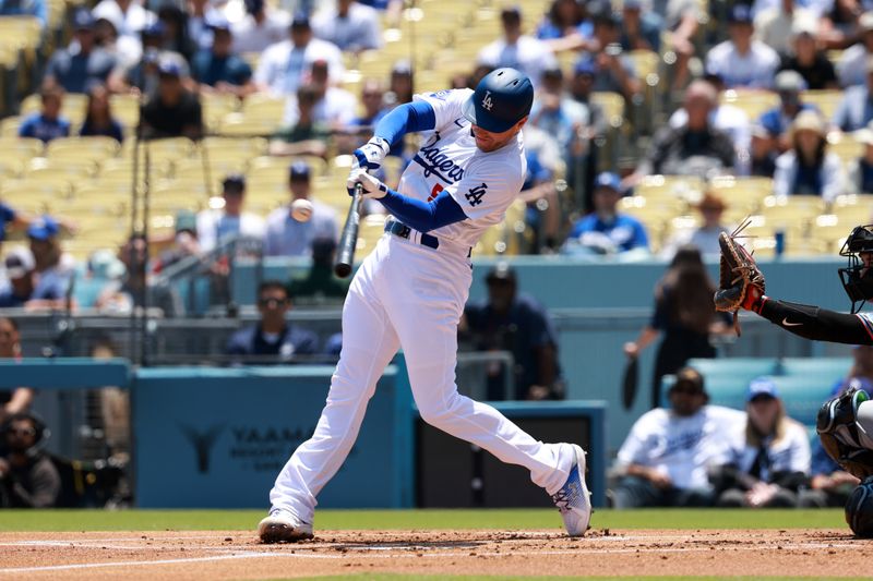 May 8, 2024; Los Angeles, California, USA;  Los Angeles Dodgers first base Freddie Freeman (5) hits a single during the first inning against the Miami Marlins at Dodger Stadium. Mandatory Credit: Kiyoshi Mio-USA TODAY Sports