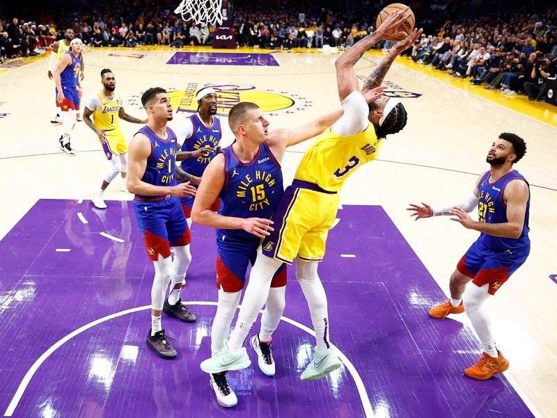 LOS ANGELES, CALIFORNIA - APRIL 25:  Anthony Davis #3 of the Los Angeles Lakers takes a shot against Nikola Jokic #15 of the Denver Nuggets in the first quarter during game three of the Western Conference First Round Playoffs at Crypto.com Arena on April 25, 2024 in Los Angeles, California.  (Photo by Ronald Martinez/Getty Images)