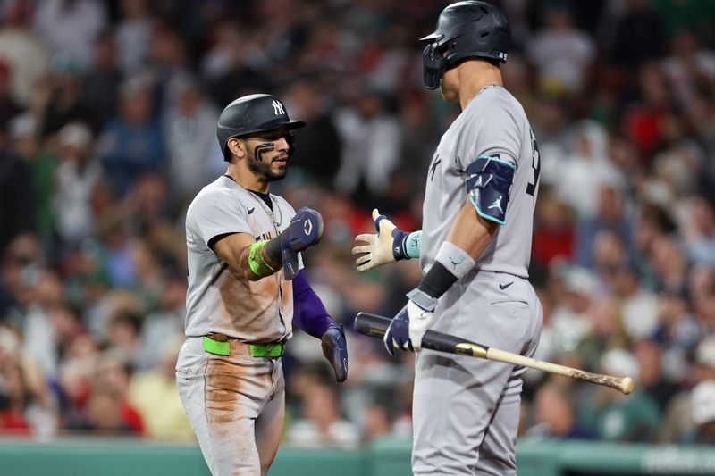 Sep 12, 2025; Boston, Massachusetts, USA; New York Yankees shortstop Jose Caballero (72) high fives New York Yankees designated hitter Aaron Judge (99) after scoring during the seventh inning against the Boston Red Sox at Fenway Park. Mandatory Credit: Paul Rutherford-Imagn Images