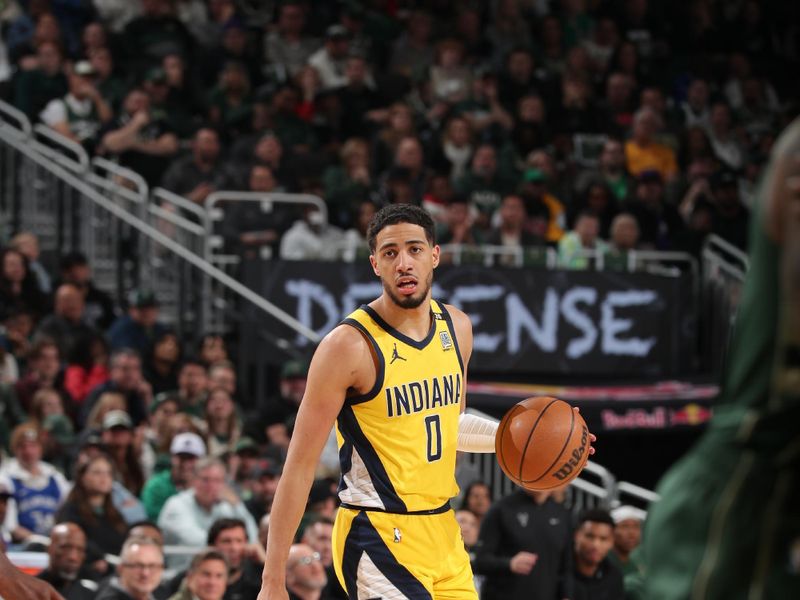 MILWAUKEE, WI - APRIL 21: Tyrese Haliburton #0 of the Indiana Pacers dribbles the ball during the game against the Milwaukee Bucks during Round 1 Game 1 of the 2024 NBA Playoffs on April 21, 2024 at the Fiserv Forum Center in Milwaukee, Wisconsin. NOTE TO USER: User expressly acknowledges and agrees that, by downloading and or using this Photograph, user is consenting to the terms and conditions of the Getty Images License Agreement. Mandatory Copyright Notice: Copyright 2024 NBAE (Photo by Gary Dineen/NBAE via Getty Images).