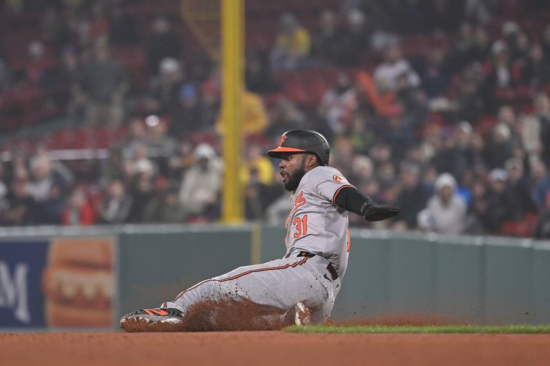 Apr 11, 20024; Boston, Massachusetts, USA; Baltimore Orioles center fielder Cedric Mullins (31) slides into second base during the ninth inning against the Boston Red Sox at Fenway Park. Mandatory Credit: Eric Canha-USA TODAY Sports