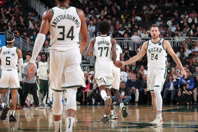 MILWAUKEE, WI - OCTOBER 14: Pat Connaughton #24 and AJ Johnson #77 of the Milwaukee Bucks high five during the game against the Chicago Bulls on October 14, 2024 at Fiserv Forum Center in Milwaukee, Wisconsin. NOTE TO USER: User expressly acknowledges and agrees that, by downloading and or using this Photograph, user is consenting to the terms and conditions of the Getty Images License Agreement. Mandatory Copyright Notice: Copyright 2024 NBAE (Photo by Gary Dineen/NBAE via Getty Images).