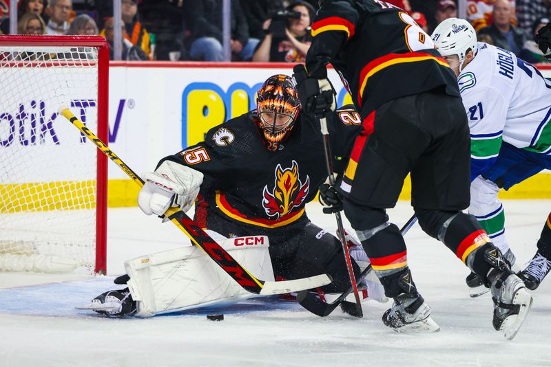 Dec 2, 2023; Calgary, Alberta, CAN; Calgary Flames goaltender Jacob Markstrom (25) makes a save against Vancouver Canucks left wing Nils Hoglander (21) during the third period at Scotiabank Saddledome. Mandatory Credit: Sergei Belski-USA TODAY Sports