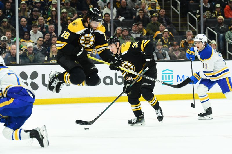 Mar 17, 2025; Boston, Massachusetts, USA;  Boston Bruins center Pavel Zacha (18) jumps out of the way of center Morgan Geekie (39) during the first period against the Buffalo Sabres at TD Garden. Mandatory Credit: Bob DeChiara-Imagn Images