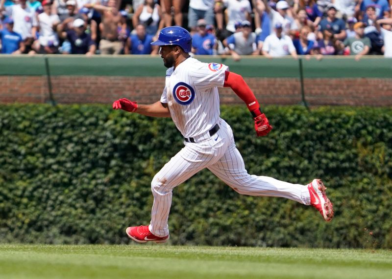 Aug 19, 2023; Chicago, Illinois, USA; Chicago Cubs third baseman Jeimer Candelario (9) runs to third base with a triple against the Kansas City Royals during the second inning at Wrigley Field. Mandatory Credit: David Banks-USA TODAY Sports