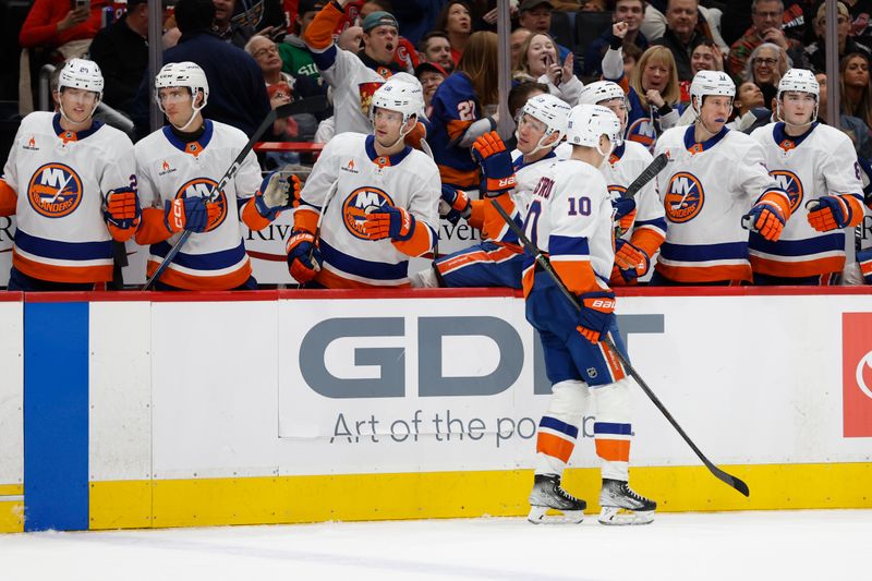 Nov 29, 2024; Washington, District of Columbia, USA; New York Islanders right wing Simon Holmstrom (10) celebrates with teammates after scoring a goal against the Washington Capitals in the second period at Capital One Arena. Mandatory Credit: Geoff Burke-Imagn Images