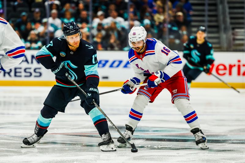 Nov 17, 2024; Seattle, Washington, USA; Seattle Kraken center Jaden Schwartz (17) passes the puck away from New York Rangers center Vincent Trocheck (16) during the third period at Climate Pledge Arena. Mandatory Credit: Joe Nicholson-Imagn Images