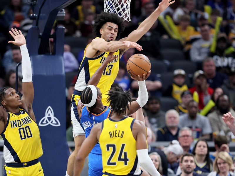 INDIANAPOLIS, INDIANA - MARCH 31:  Jordan Nwora #13 of the Indiana Pacers defends the shot of Shai Gilgeous-Alexander #2 of the Oklahoma City Thunder at Gainbridge Fieldhouse on March 31, 2023 in Indianapolis, Indiana.    NOTE TO USER: User expressly acknowledges and agrees that, by downloading and/or using this photograph, User is consenting to the terms and conditions of the Getty Images License Agreement. (Photo by Andy Lyons/Getty Images)