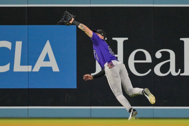 Sep 10, 2025; Los Angeles, California, USA; Colorado Rockies center fielder Brenton Doyle (9) makes a catch off of a ball hit by Los Angeles Dodgers first baseman Freddie Freeman (not pictured) in the first inning at Dodger Stadium. Mandatory Credit: Jayne Kamin-Oncea-Imagn Images