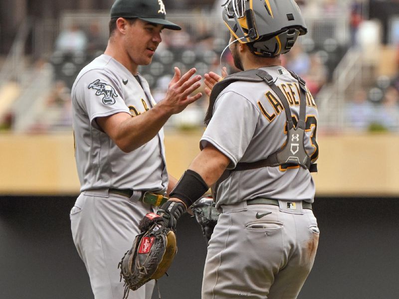 Sep 28, 2023; Minneapolis, Minnesota, USA; Oakland Athletics pitcher Trevor May (65) and catcher Shea Langeliers (23) celebrate a victory over the Minnesota Twins at Target Field. Mandatory Credit: Nick Wosika-USA TODAY Sports