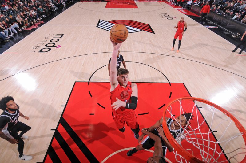 PORTLAND, OR - DECEMBER 13: Donovan Clingan #23 of the Portland Trail Blazers drives to the basket during the game against the San Antonio Spurs on December 13, 2024 at the Moda Center Arena in Portland, Oregon. NOTE TO USER: User expressly acknowledges and agrees that, by downloading and or using this photograph, user is consenting to the terms and conditions of the Getty Images License Agreement. Mandatory Copyright Notice: Copyright 2024 NBAE (Photo by Cameron Browne/NBAE via Getty Images)