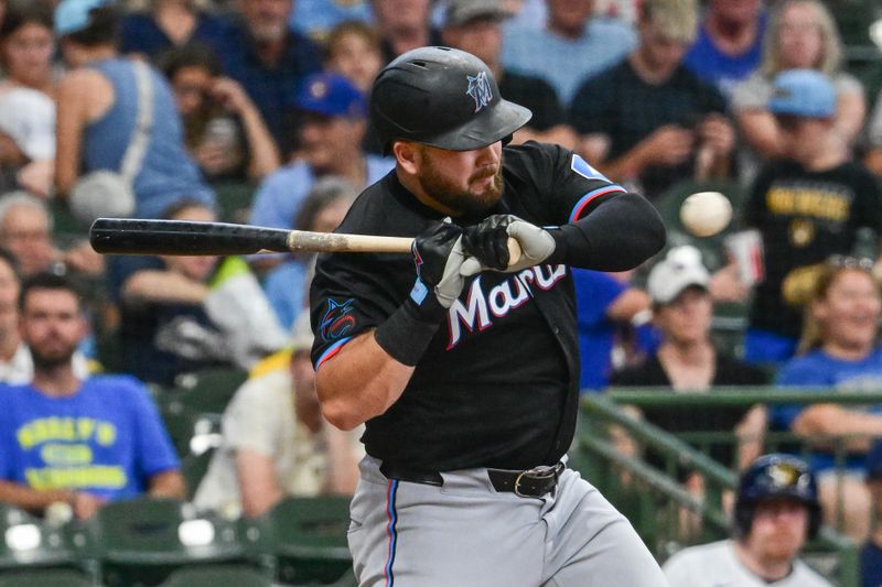 Jul 28, 2024; Milwaukee, Wisconsin, USA; Miami Marlins third baseman Jake Burger (36) is hit by a pitch in the third inning against the Milwaukee Brewers at American Family Field. Mandatory Credit: Benny Sieu-USA TODAY Sports