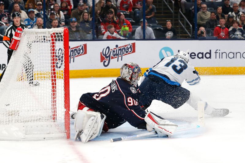 Nov 1, 2024; Columbus, Ohio, USA; Columbus Blue Jackets goalie Elvis Merzlikins (90) makes a save from the shot of Winnipeg Jets center Gabriel Vilardi (13) during the first period at Nationwide Arena. Mandatory Credit: Russell LaBounty-Imagn Images