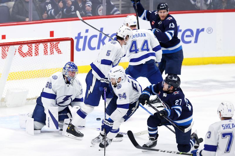 Jan 2, 2024; Winnipeg, Manitoba, CAN; Winnipeg Jets left wing Nikolaj Ehlers (27) scores goal in the third period on Tampa Bay Lightning goaltender Andrei Vasilevskiy (88) at Canada Life Centre. Mandatory Credit: James Carey Lauder-USA TODAY Sports