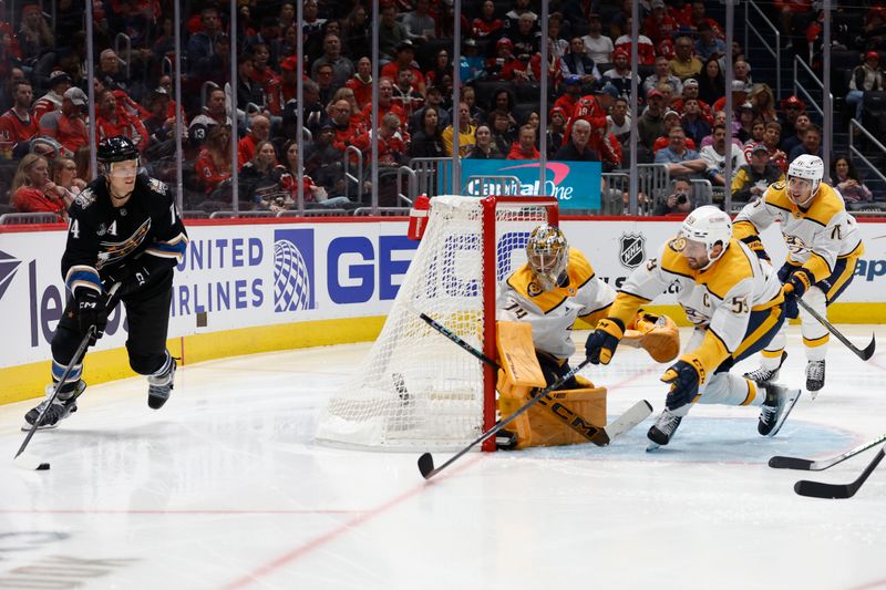 Nov 6, 2024; Washington, District of Columbia, USA; Washington Capitals defenseman John Carlson (74) skates with the puck behind Nashville Predators goaltender Juuse Saros (74) as Predators defenseman Roman Josi (59) defends in the third period at Capital One Arena. Mandatory Credit: Geoff Burke-Imagn Images