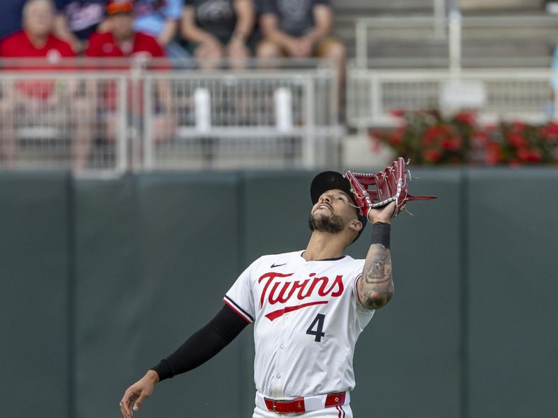 Jun 19, 2024; Minneapolis, Minnesota, USA; Minnesota Twins shortstop Carlos Correa (4) catches a fly ball against the Tampa Bay Rays in the fourth inning at Target Field. Mandatory Credit: Jesse Johnson-USA TODAY Sports