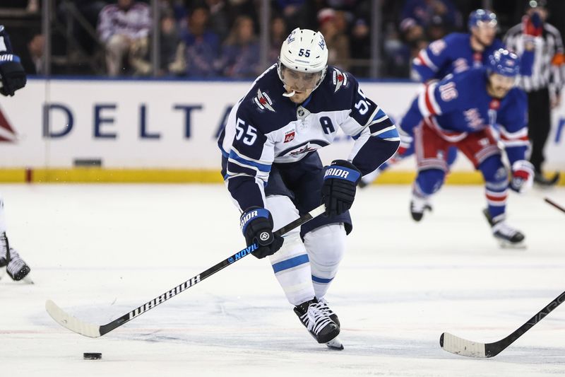 Nov 12, 2024; New York, New York, USA;  Winnipeg Jets center Mark Scheifele (55) chases the puck in the first period against the New York Rangers at Madison Square Garden. Mandatory Credit: Wendell Cruz-Imagn Images