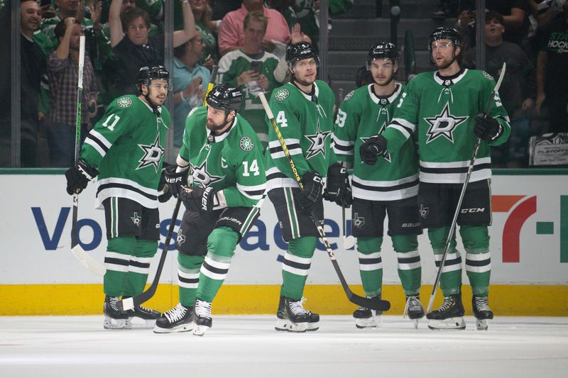 May 25, 2024; Dallas, Texas, USA; Dallas Stars center Logan Stankoven (11) and left wing Jamie Benn (14) and d42 and center Wyatt Johnston (53) a d defenseman Thomas Harley (55) celebrates a goal scored by Benn against the Edmonton Oilers during the first period in game two of the Western Conference Final of the 2024 Stanley Cup Playoffs at American Airlines Center. Mandatory Credit: Jerome Miron-USA TODAY Sports