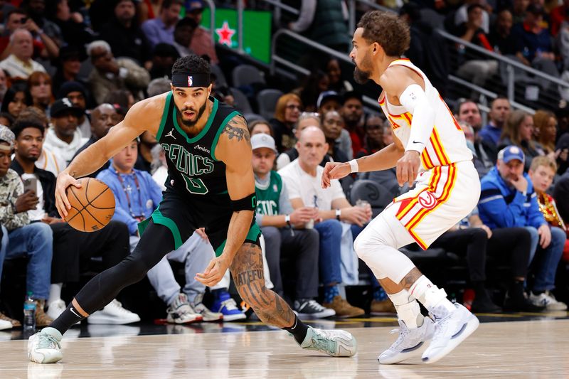 ATLANTA, GEORGIA - NOVEMBER 4: Jayson Tatum #0 of the Boston Celtics drives against Trae Young #11 of the Atlanta Hawks during the second quarter at State Farm Arena on November 4, 2024 in Atlanta, Georgia. NOTE TO USER: User expressly acknowledges and agrees that, by downloading and or using this photograph, User is consenting to the terms and conditions of the Getty Images License Agreement. (Photo by Todd Kirkland/Getty Images)