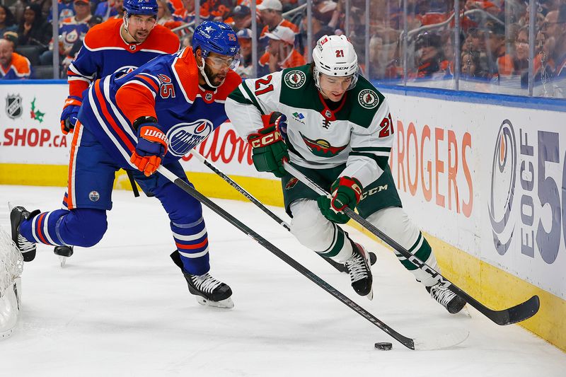 Dec 8, 2023; Edmonton, Alberta, CAN;  Edmonton Oilers defensemen Darnell Nurse (25) and Minnesota Wild forward Brandon Duhaime (21) battle along the boards for a loose puck during the second periodat Rogers Place. Mandatory Credit: Perry Nelson-USA TODAY Sports